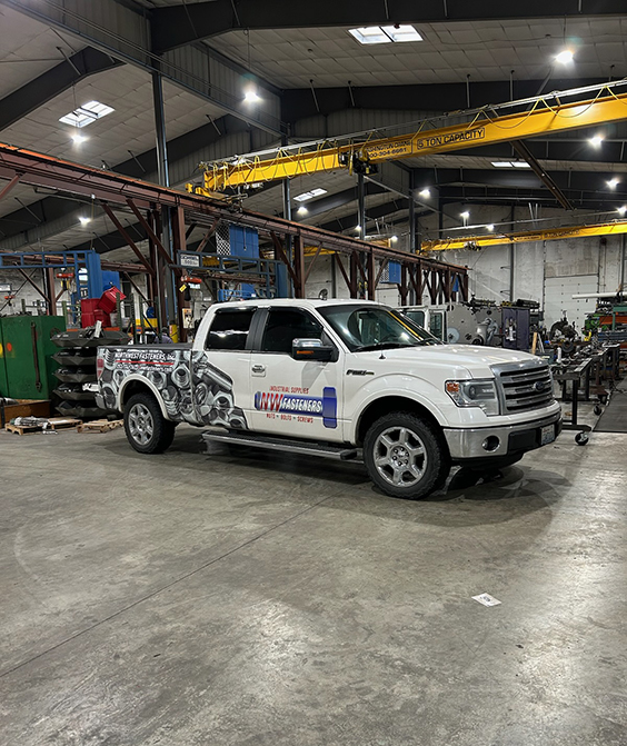 Northwest Fasteners wrapped delivery truck inside a customer's fabrication shop
